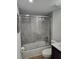 Updated bathroom features a shower over tub with gray tile surround, a modern vanity, and fresh fixtures at 535 Midway Dr # A, Ocala, FL 34472