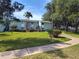 Green building exterior with well-maintained landscaping and sidewalk access at 535 Midway Dr # A, Ocala, FL 34472
