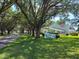 Picturesque Live Oak Village entrance with mature trees, lush lawns, and well-maintained landscaping creates inviting curb appeal at 535 Midway Dr # A, Ocala, FL 34472