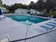 Large community pool with lounge chairs, tables and chairs providing a refreshing and relaxing outdoor amenity at 535 Midway Dr # A, Ocala, FL 34472