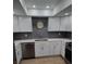 Updated kitchen with white cabinets, gray backsplash, stainless steel appliances, and modern countertops at 535 Midway Dr # A, Ocala, FL 34472