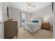 Comfortable bedroom with natural light, a ceiling fan, and neutral decor, perfect for relaxation at 6185 Sw 89Th Ct, Ocala, FL 34481