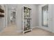 Welcoming entryway featuring a decorative glass door, a display cabinet, and light tile flooring at 6185 Sw 89Th Ct, Ocala, FL 34481