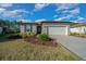 Charming single-story home with a well-manicured lawn, tasteful landscaping, and an attached two-car garage at 6185 Sw 89Th Ct, Ocala, FL 34481