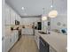Modern kitchen with stainless steel appliances, quartz countertops, white cabinetry, and an open layout at 6185 Sw 89Th Ct, Ocala, FL 34481
