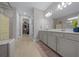 Spacious main bathroom with double vanity, walk-in closet, linen closet, and a separate glass-enclosed shower at 6185 Sw 89Th Ct, Ocala, FL 34481