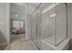 Contemporary glass enclosed shower with bench seating and mosaic tile accents in the main bathroom at 6185 Sw 89Th Ct, Ocala, FL 34481