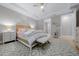 Another view of the main bedroom showcasing the ceiling fan, neutral decor, and access to the ensuite bathroom at 6185 Sw 89Th Ct, Ocala, FL 34481