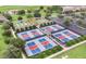 Aerial view of pickleball courts, bocce ball and immaculate landscaping make this community fun at 6185 Sw 89Th Ct, Ocala, FL 34481