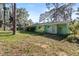 View of the exterior backyard with grass and trees under a clear sky at 641 Jackson St, Eustis, FL 32726