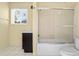 Bathroom with shower and tub, window, toilet and single sink at 641 Jackson St, Eustis, FL 32726