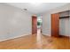 Bedroom with hardwood floors, neutral wall paint, and a closet with sliding doors at 641 Jackson St, Eustis, FL 32726