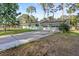 Low angle shot of the exterior of a house featuring a large driveway and a two car garage at 641 Jackson St, Eustis, FL 32726