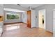 Living room featuring wood floor, window, and view to a yellow room at 641 Jackson St, Eustis, FL 32726
