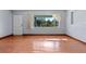Spacious living room with large window providing natural light and a wood floor at 641 Jackson St, Eustis, FL 32726