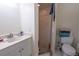 Bright bathroom features a white vanity with sink, toilet, and glass-enclosed shower at 1695 Horseshoe Rd, Deltona, FL 32725