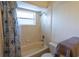 Bathroom with shower/tub combination, tile surround, and blue shower curtain at 1695 Horseshoe Rd, Deltona, FL 32725