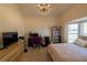 Bedroom featuring a bed, workspace, large window, and stylish chandelier at 1695 Horseshoe Rd, Deltona, FL 32725