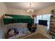 Charming bedroom with bunk bed, chandelier, and ample natural light at 1695 Horseshoe Rd, Deltona, FL 32725