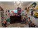 Toy-filled bedroom with ample shelving, a dresser, and a chandelier at 1695 Horseshoe Rd, Deltona, FL 32725