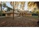 Charming single-story home with a tile roof surrounded by lush, mature trees in a serene landscape at 1695 Horseshoe Rd, Deltona, FL 32725