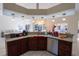 Open kitchen with granite countertops and stainless appliances, overlooking the living area at 1695 Horseshoe Rd, Deltona, FL 32725