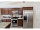 Stylish kitchen boasts stainless steel appliances, granite counters and rich wood cabinets at 1695 Horseshoe Rd, Deltona, FL 32725