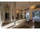 Spacious living room featuring tile floors, elegant chandeliers, and picturesque views of the backyard at 1695 Horseshoe Rd, Deltona, FL 32725