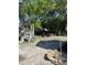 Spacious backyard with mature trees, partially paved area, and natural elements, ideal for outdoor enjoyment at 705 Grape Ave, St Cloud, FL 34769