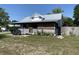 Charming single-story home with a metal roof, lattice accents, and a cozy front porch area at 705 Grape Ave, St Cloud, FL 34769