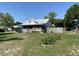 Charming single-story home featuring a metal roof and inviting front porch with a picket fence at 705 Grape Ave, St Cloud, FL 34769