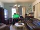 Cozy living room with vintage furniture, textured walls, and decor; a comfortable and lived-in space at 705 Grape Ave, St Cloud, FL 34769