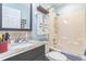 Bathroom features a vanity with granite countertop, a mirror, and a shower/tub with a towel rack at 9107 Sw 102Nd Cir, Ocala, FL 34481