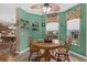 Bright breakfast nook featuring light-filled windows, a ceiling fan, and a classic table set for casual dining at 9107 Sw 102Nd Cir, Ocala, FL 34481