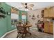 Cozy breakfast nook showcasing a round wooden table and bright windows, perfect for enjoying casual meals at 9107 Sw 102Nd Cir, Ocala, FL 34481