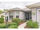 Inviting entryway with decorative details, manicured landscaping, and ample natural light at 9107 Sw 102Nd Cir, Ocala, FL 34481