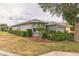 Exterior shot shows attractive landscaping, and a gray exterior at 9107 Sw 102Nd Cir, Ocala, FL 34481