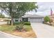 Charming home features a well-manicured lawn, mature trees, and an attached two-car garage at 9107 Sw 102Nd Cir, Ocala, FL 34481