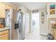 Bright kitchen area with stainless steel refrigerator, adjacent to the laundry room for added convenience at 9107 Sw 102Nd Cir, Ocala, FL 34481