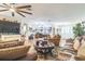 Open concept living room with hardwood floors, ceiling fans, and comfortable furniture at 9107 Sw 102Nd Cir, Ocala, FL 34481