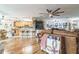 Open-concept living space featuring hardwood floors, ceiling fans, and natural light at 9107 Sw 102Nd Cir, Ocala, FL 34481