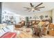 Spacious living room featuring hardwood floors, a ceiling fan, and comfortable leather seating for relaxing and entertaining at 9107 Sw 102Nd Cir, Ocala, FL 34481