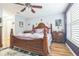 Serene main bedroom boasting hardwood floors, a ceiling fan, and comfortable furnishing for relaxing after a long day at 9107 Sw 102Nd Cir, Ocala, FL 34481