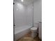 Bathroom featuring new toilet and bathtub with bright white subway tile surround at 991 Polk St, Bartow, FL 33830