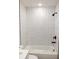 Modern bathroom featuring new bathtub with a subway tile backsplash and black fixtures at 991 Polk St, Bartow, FL 33830