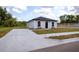 Freshly painted single-story home with a new driveway, modern roof and landscaping at 991 Polk St, Bartow, FL 33830