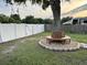 Scenic view of a tree with a circular bench surrounding it in a spacious backyard at 10470 Sw 132Nd Ct, Dunnellon, FL 34432