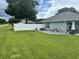 A spacious backyard, with a stone patio, complemented by vibrant potted plants at 10470 Sw 132Nd Ct, Dunnellon, FL 34432