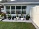 An exterior shot of the back of the home, showing a rock garden under the windows at 10470 Sw 132Nd Ct, Dunnellon, FL 34432