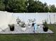 Backyard rock garden with assorted potted plants at 10470 Sw 132Nd Ct, Dunnellon, FL 34432